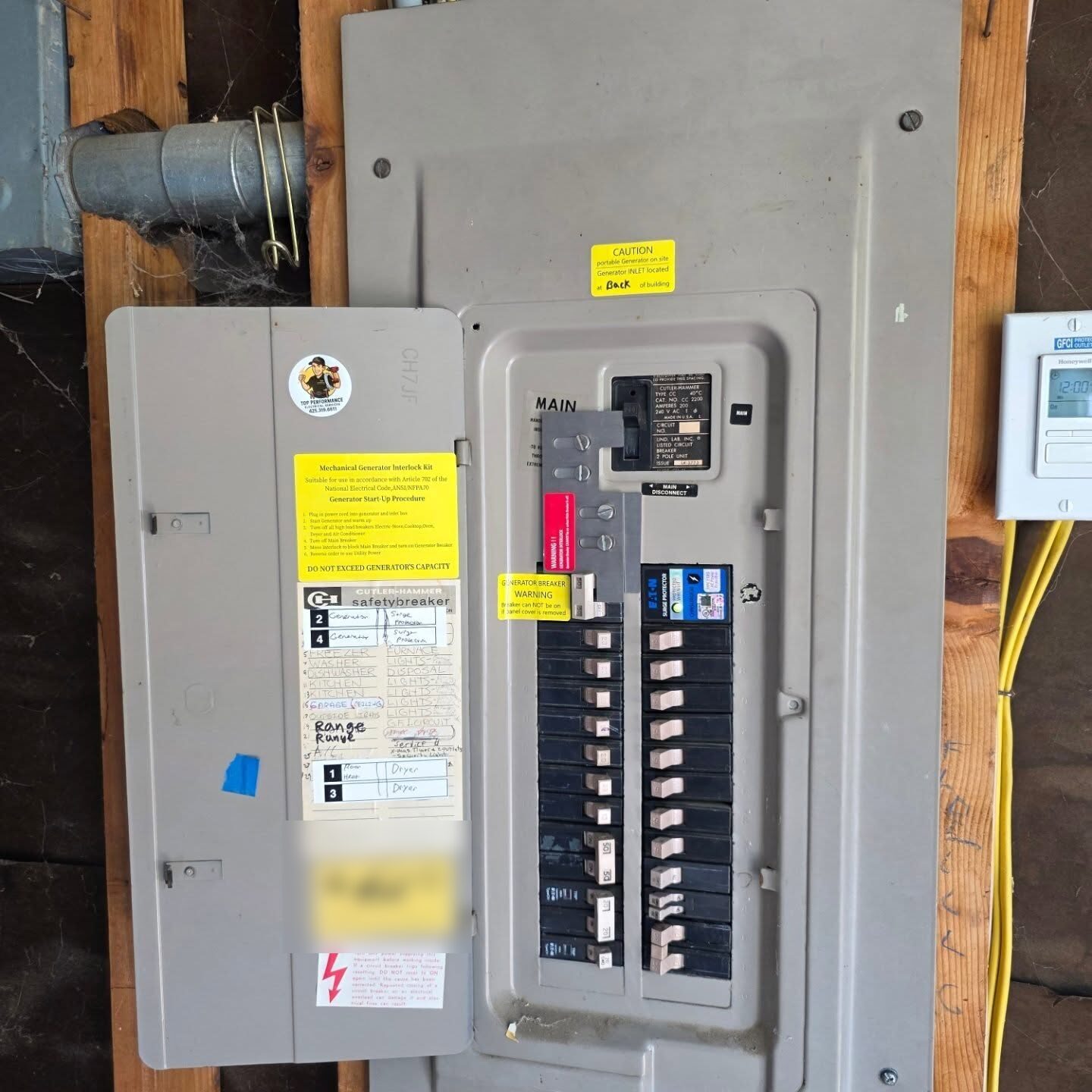 Mechanical generator interlock kit and hand-labeled circuit directory inside an open panel