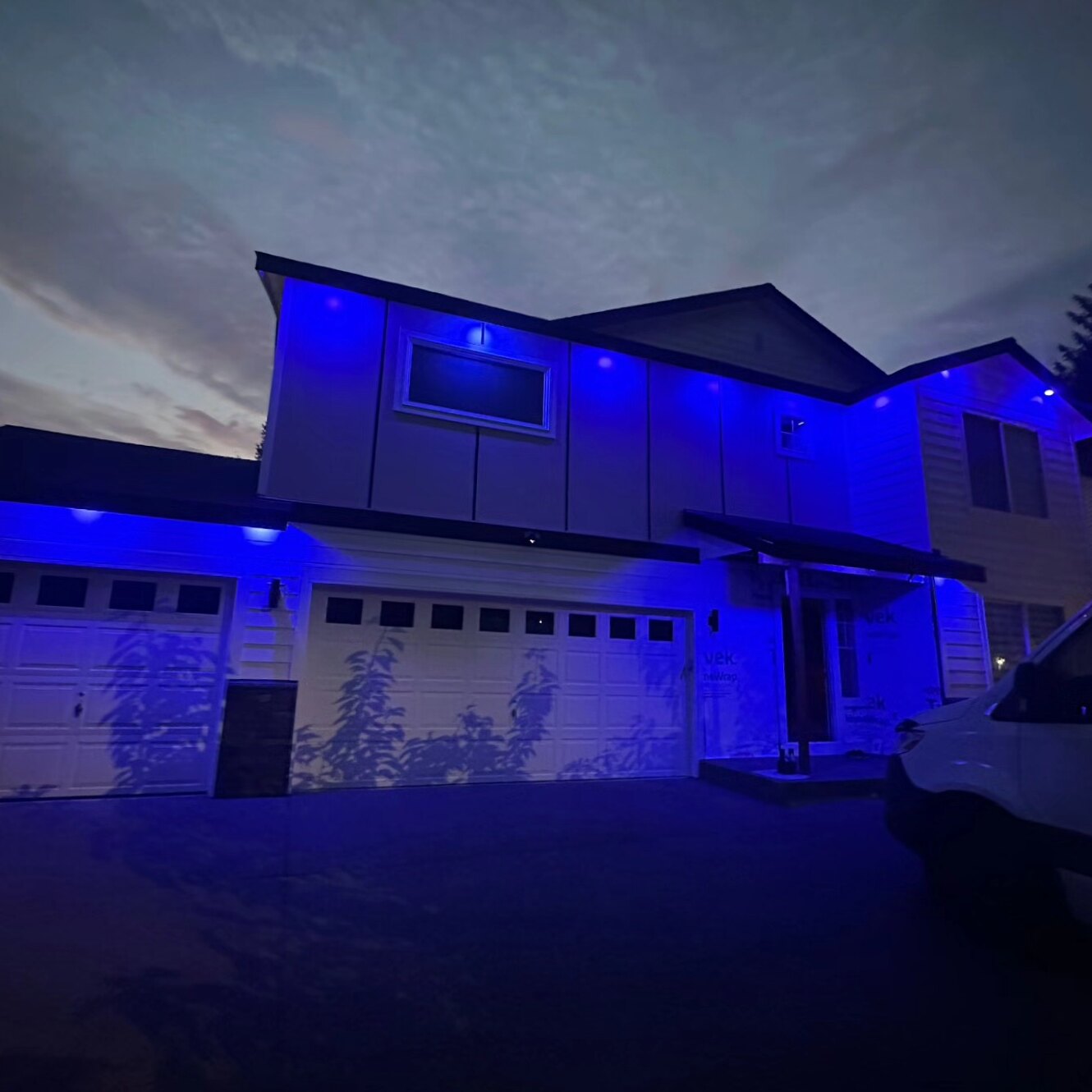 Color-changing exterior soffit lighting glowing blue at night